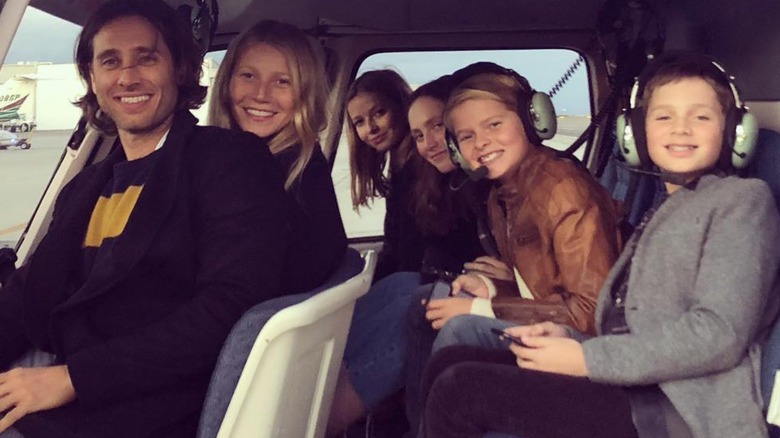 Gwyneth Paltrow, Moses Martin, Apple Martin, Brad Falchuk, Isabella, and Brody smiling in a helicopter