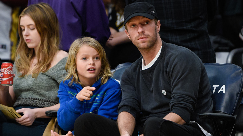 Chris Martin and Moses Martin watching a basketball game at Staples Center