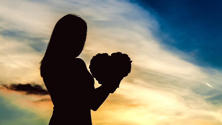 woman holding a heart-shaped object