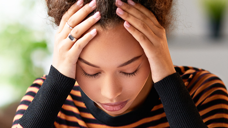 stressed woman holding her head