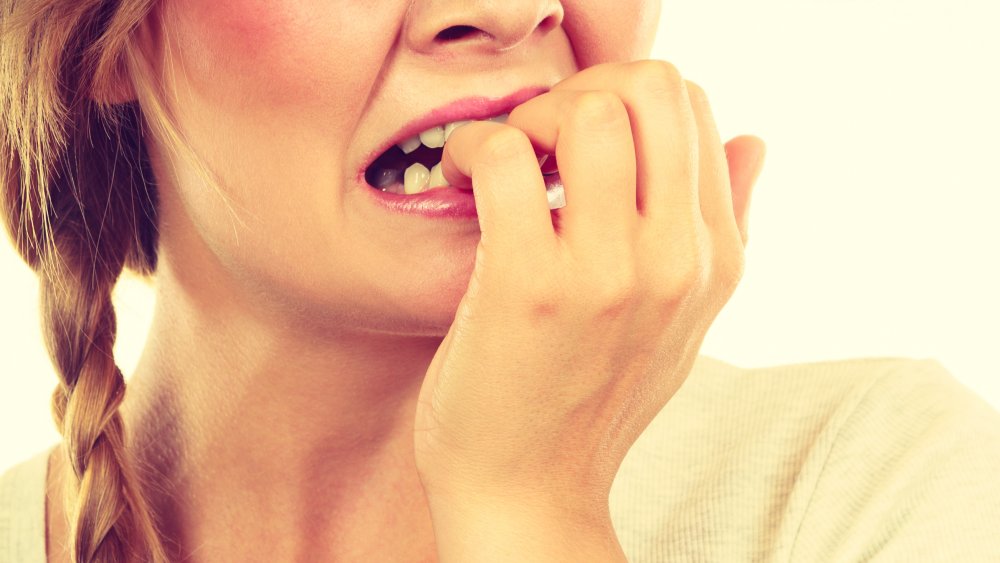 Woman biting nails