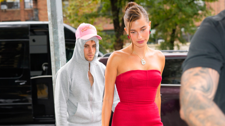 Justin Bieber and wife Hailey Bieber walking outside.