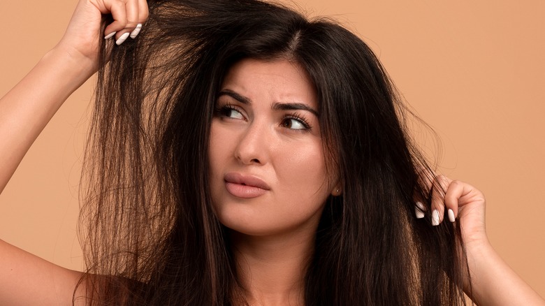 Woman tugging her long hair