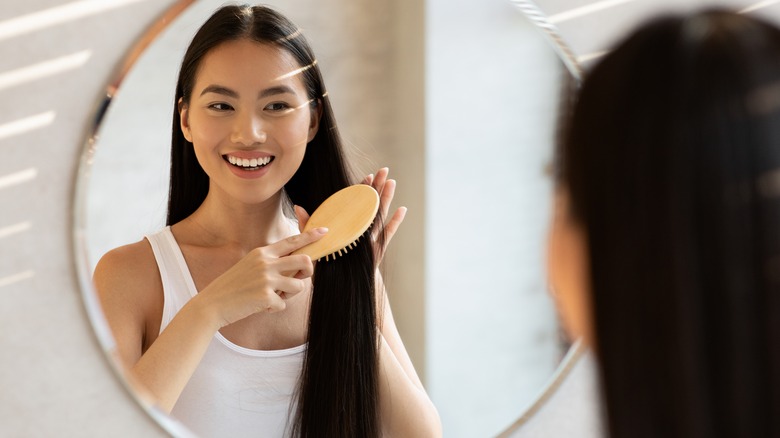 woman brushing hair, brushing healthy long hair 