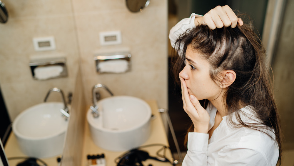 Woman looking at her hair