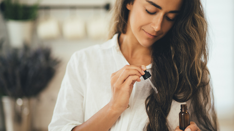 Woman oiling her hair