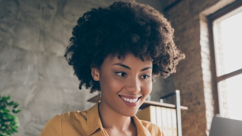 Woman with natural hair smiling