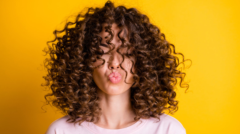 Woman with curly hair posing