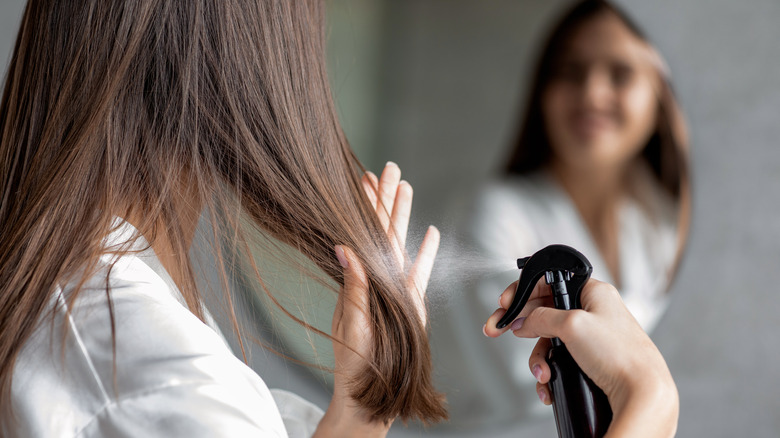 person using hairspray