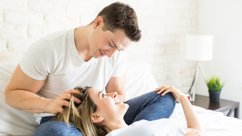 man massaging woman's scalp