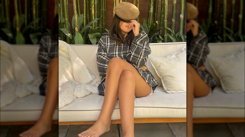 Nahla Aubrey posing with a hat covering her face