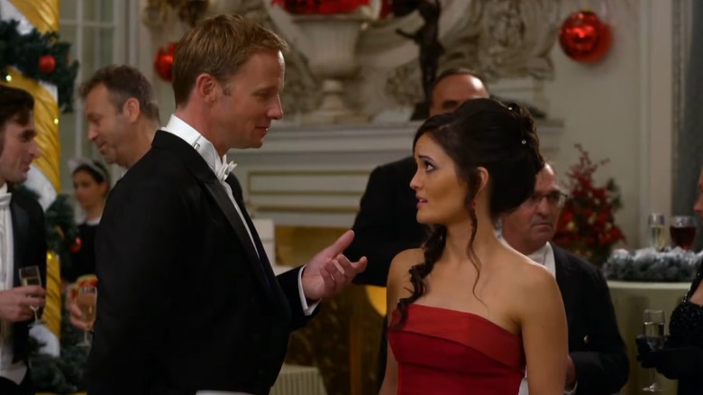 Rupert Penry-Jones reaching out for Danica McKellar's hand