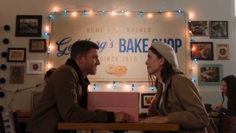 Bryan Greenberg and Vic Michaelis﻿ smiling at each other from across a table