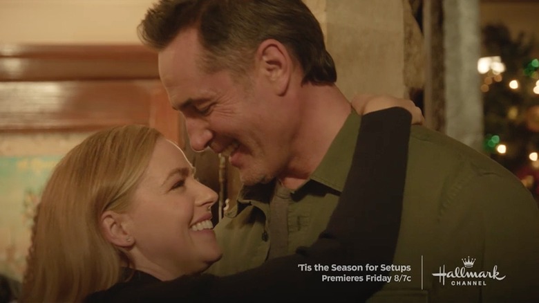 Blonde woman and man embracing and smiling