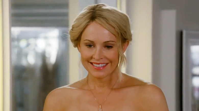 Josie Bissett smiling with her blond hair in an updo