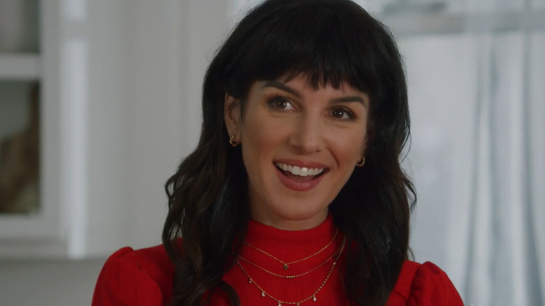 Shenae Grimes smiling with long dark hair and bangs