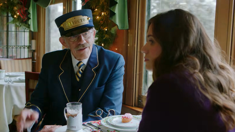 Hallmark Christmas movie "Next Stop, Christmas," starring Lyndsy Fonseca as Angie Reynolds and Christopher Lloyd as the train conductor.