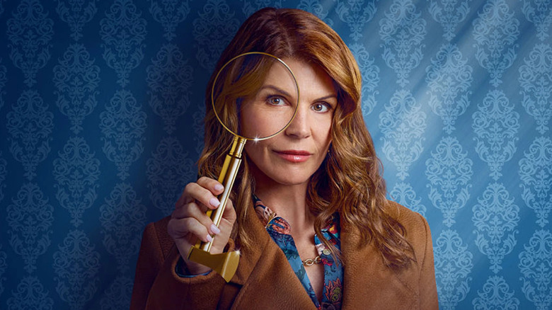 Lori Loughlin looking through a magnifying glass