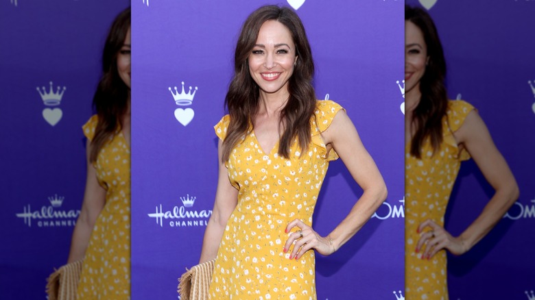 Autumn Reeser posing on the red carpet at a Hallmark media cocktail event in 2024.