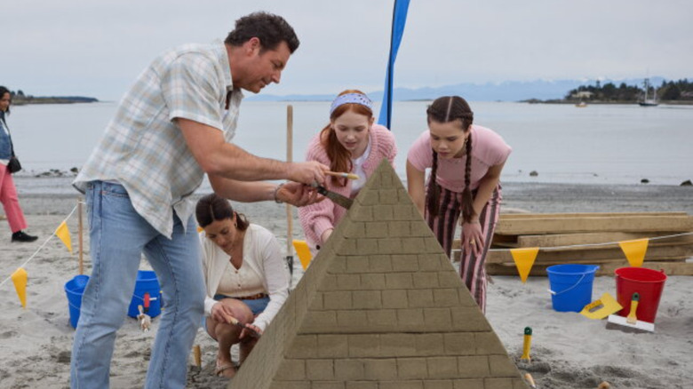 Brennan Elliot and cast in a sandcastle beach scene in "A Castle of Our Own."