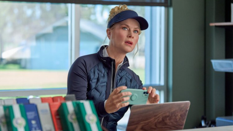 Alison Sweeney as Hannah holding her phone up to take a picture in "Best Served Cold: A Hannah Swensen Mystery"