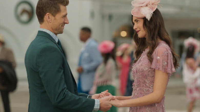 Andrew Walker as Ash (left) and Odette Annable as Sadie (right) holding hands in "Kentucky Roses."