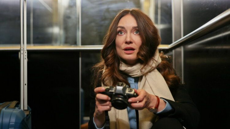 Mallory Jansen as Georgie holding a camera in "Melbourne Match"