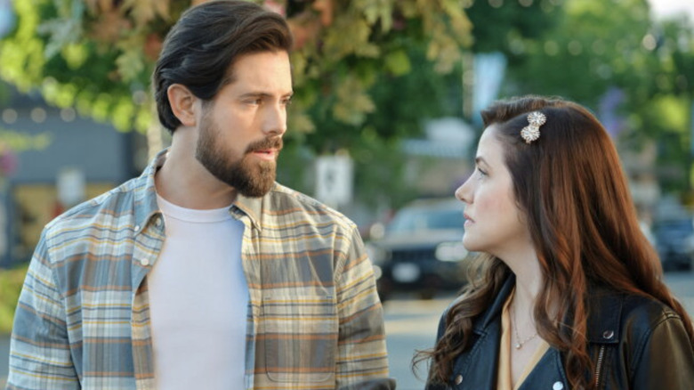 Julie Gonzalo and Chris McNally looking at each other