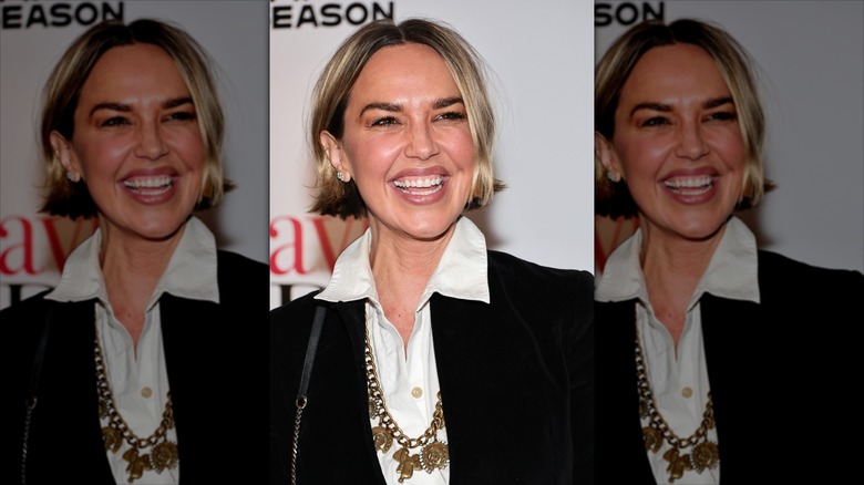 Arielle Kebbel gives a wide smile in an elegent, blunt cut blond bob at her chin