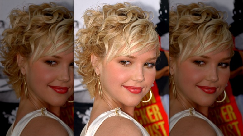 Arielle Kebbel looks over her shoulder in a tousled, textured blond pixie cut