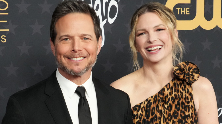 Scott Wolf and Kelley Wolf smiling while posing for photos