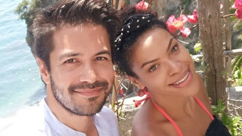 Marco Grazzini and Alvina August posing together in tropical selfie