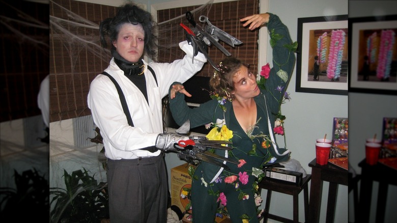 Neal Dodson dressed like Edward Scissorhands and Ashley Williams dressed like a shrub covered in flowers.