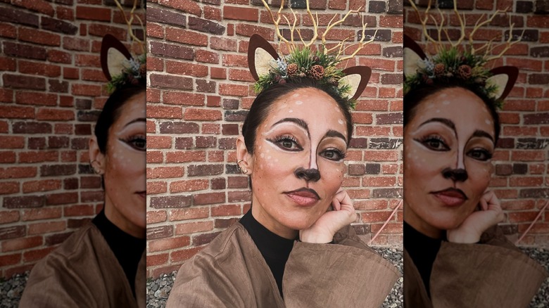 Autumn Reeser wearing a deer costume with her face painted.