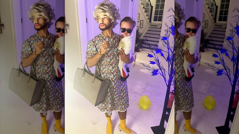 Jordan Fisher wearing a granny costume and holding his son.