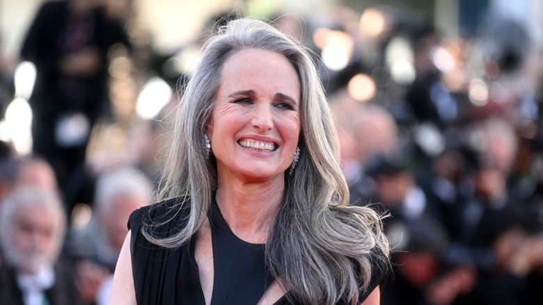 Andie MacDowell smiling outside the Cannes Film Festival