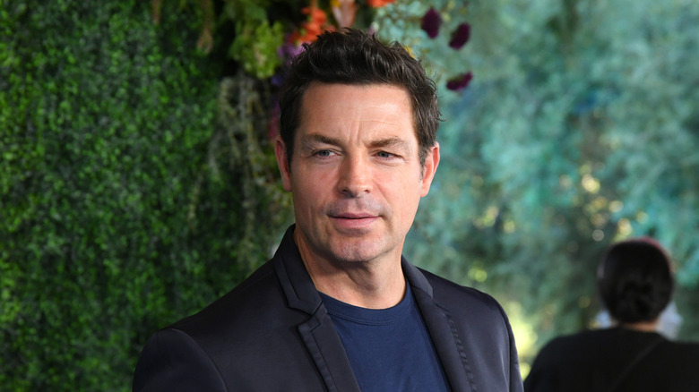 Brennan Elliott posing in front of a green background