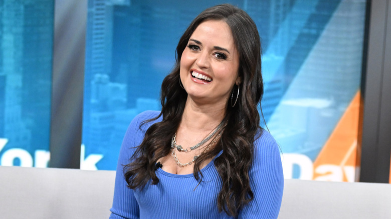 Danica McKellar sitting and posing during an appearance