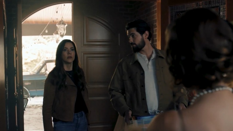Julie Gonzalo looking shocked while entering a house with Chris McNally.