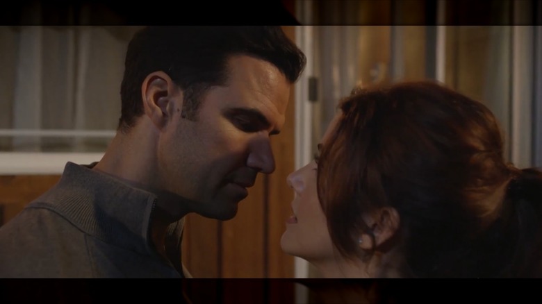 Julie Gonzalo and Benjamin Ayres nearly kissing