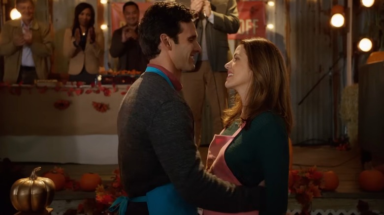 Julie Gonzalo and Eric Aragon smiling at each other