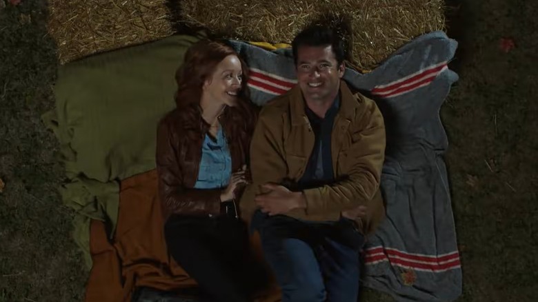 Lindy Booth and Wes Brown﻿ laughing while lying on blankets
