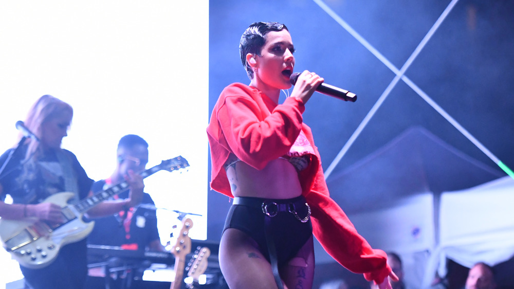 Halsey performing in red crop top