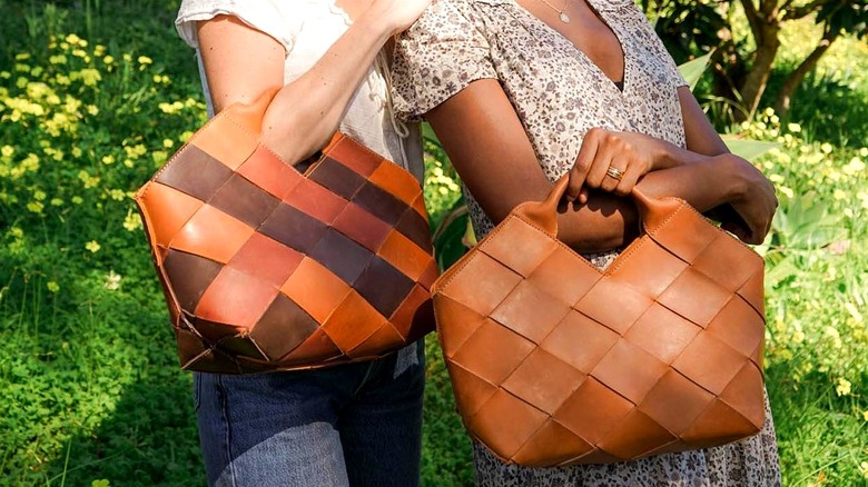 Women holding woven leather handbags