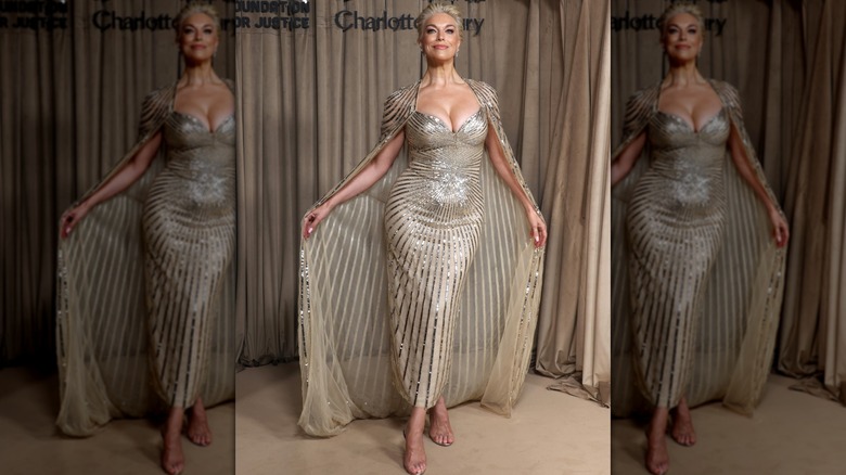 Hannah Waddingham wearing a caped champagne-colored dress with gold stripes.