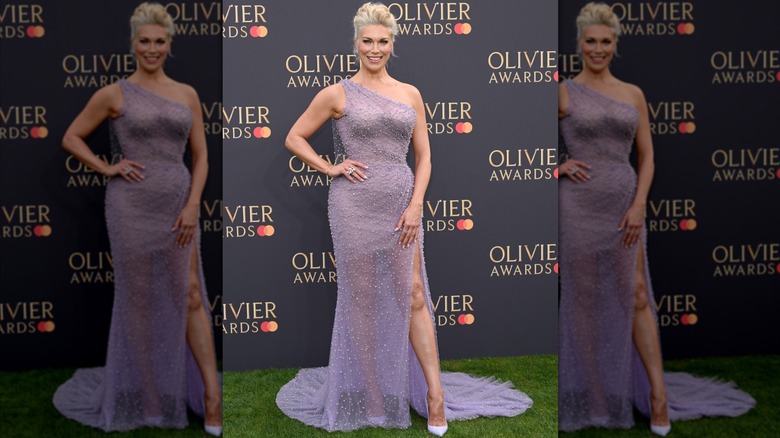Hannah Waddingham wearing a purple dress with a side slit.