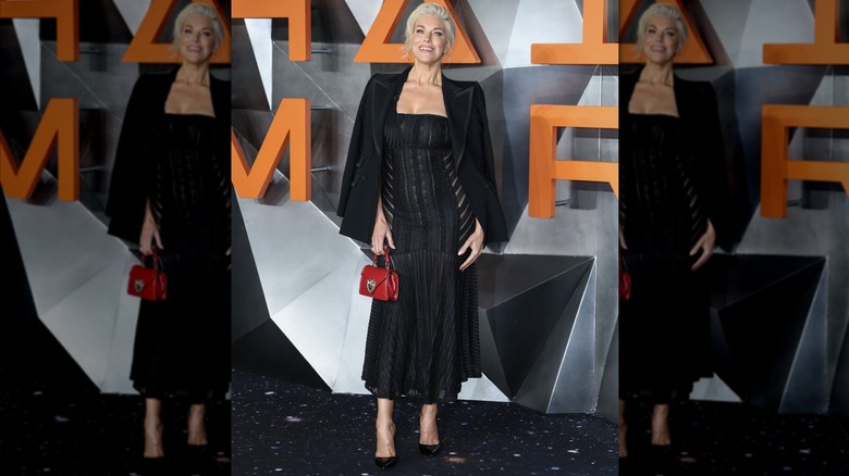 Hannah Waddingham wearing a black lace dress and black jacket.