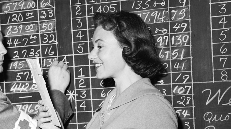 Marion Ross standing in front of a chalkboard in 1957 at a Red Cross event