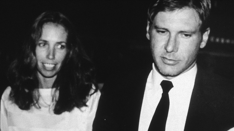Black and white photo of Melissa Mathison and Harrison Ford at an event in 1983