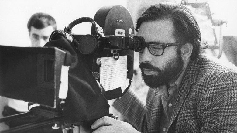 Black and white photo of Francis Ford Coppola shooting a movie